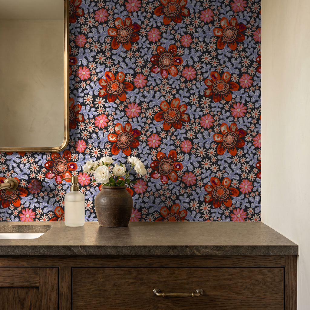 Bold floral wallpaper with red and coral blooms in a rustic bathroom setting.