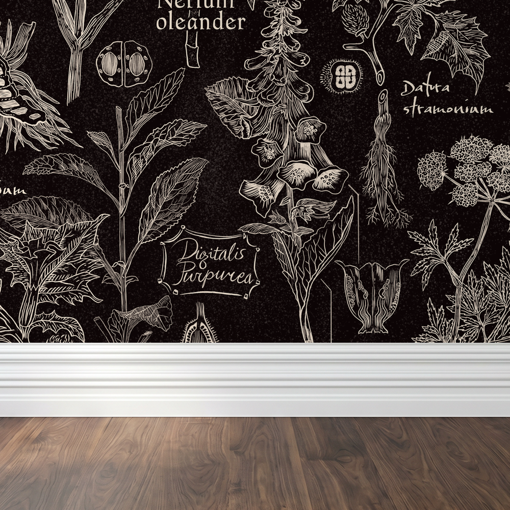 Botanical wallpaper with white plant illustrations on charcoal background in room setting.