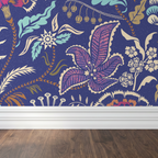 Floral wallpaper with pink, cream, and indigo motifs on ultramarine background in room setting.