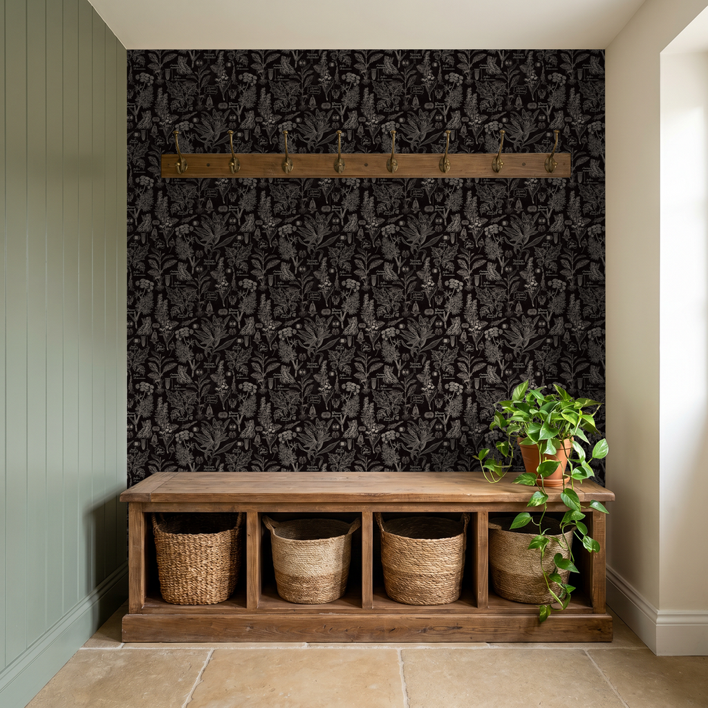 Charcoal botanical wallpaper in entryway with wooden bench and plants.