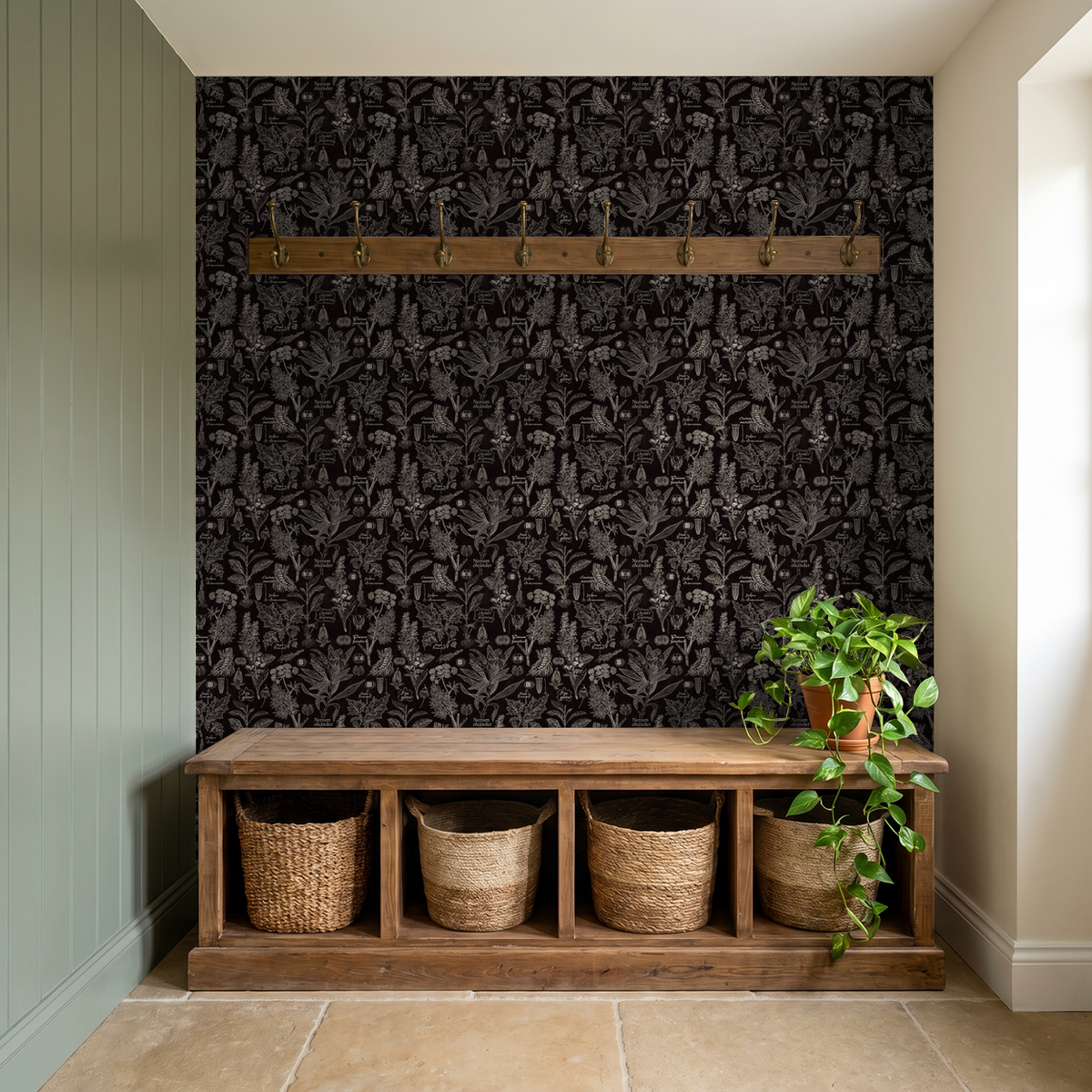 Charcoal botanical wallpaper in entryway with wooden bench and plants.