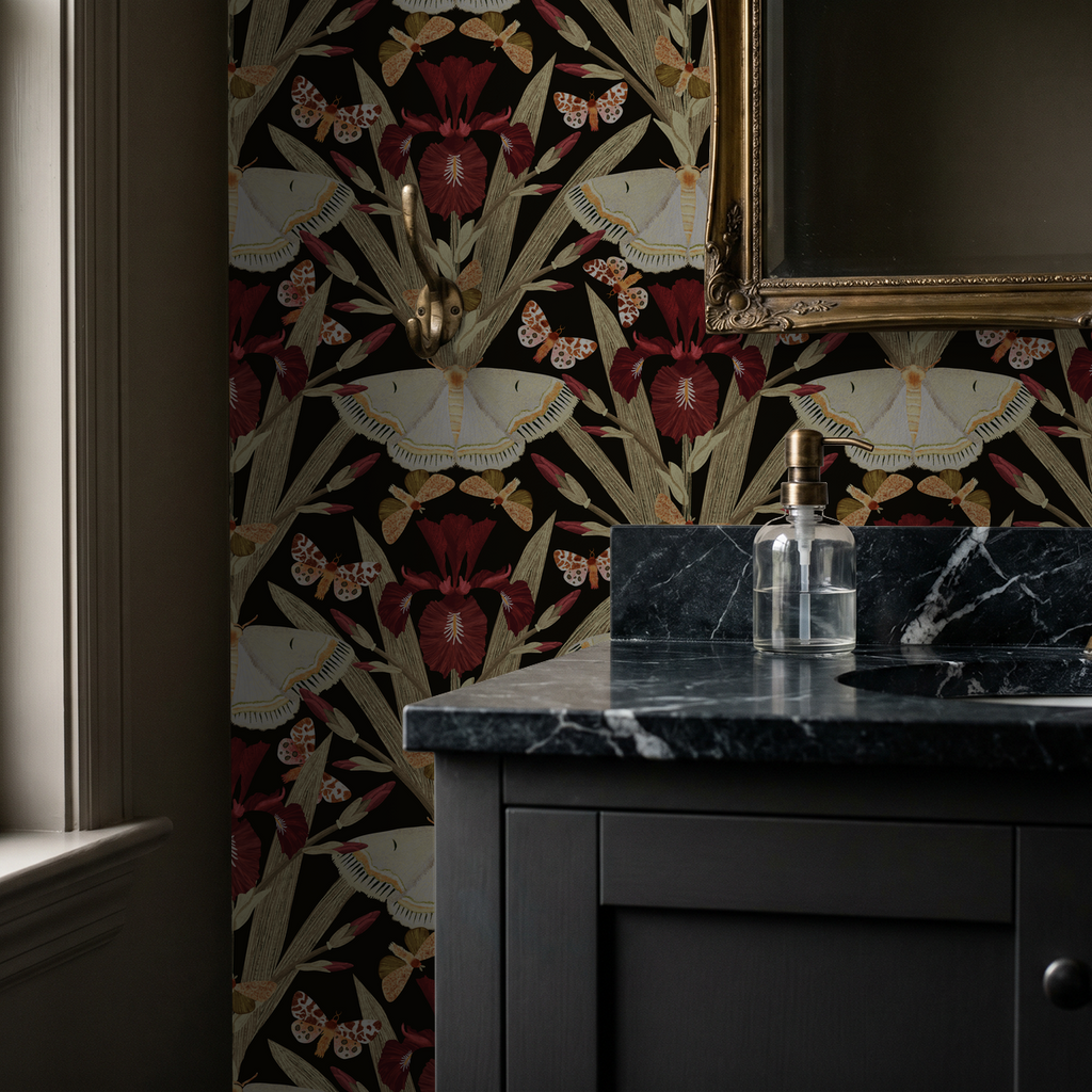 Charcoal wallpaper with burgundy irises and moths in elegant bathroom setting.