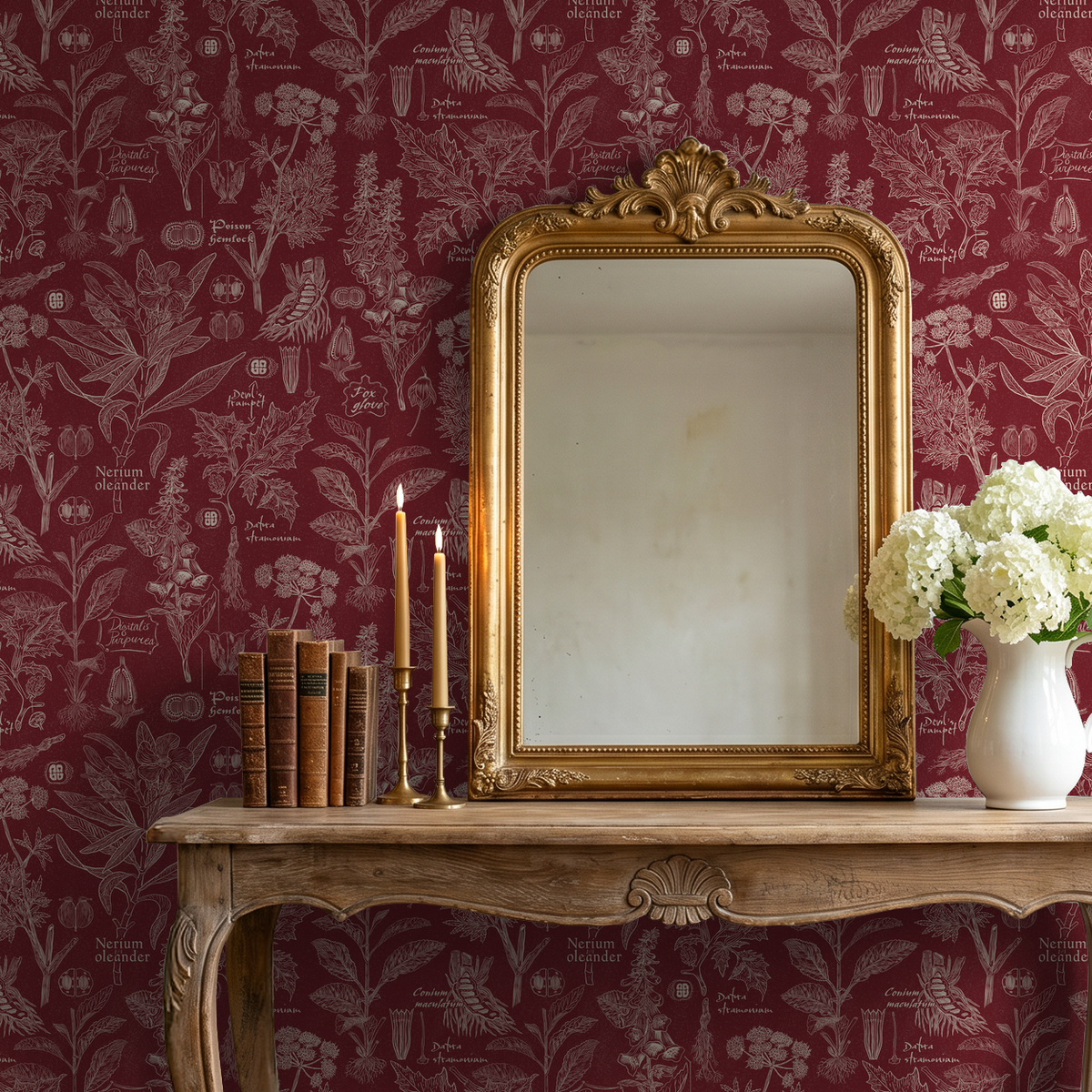 Crimson botanical wallpaper with intricate plant illustrations in a vintage-style room with a mirror and flowers.