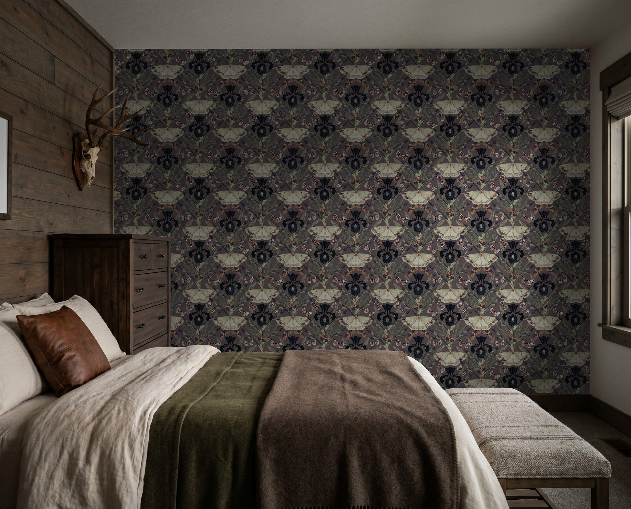 Bedroom with Dutch Iris flower and moth patterned wallpaper in muted tones.