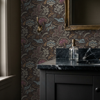 Elegant floral chintz wallpaper in muted blue and taupe in a classic bathroom.