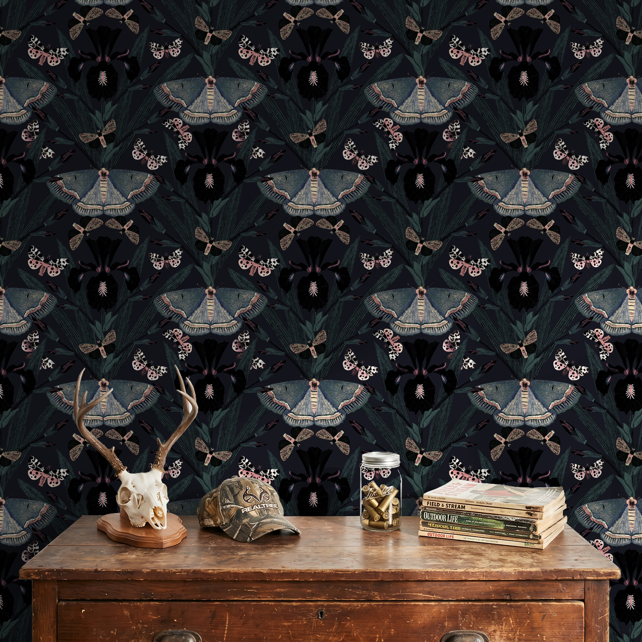 Moody wallpaper with Dutch irises and moths in a vintage room setting.