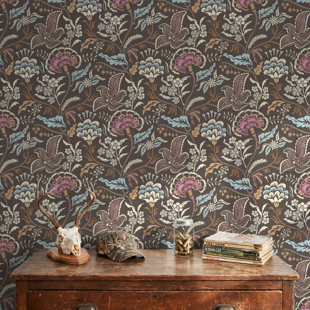 Muted blue and taupe chintz floral wallpaper in a rustic room setting.
