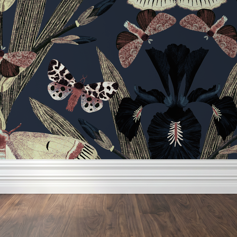 Navy wallpaper with maroon, pink moths and iris flowers in a room setting.