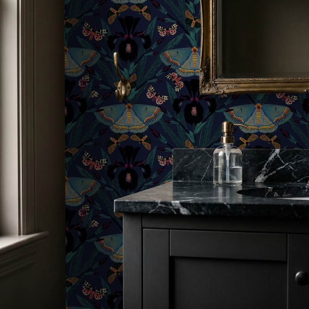 Moody navy wallpaper with moths and irises in elegant bathroom setting.
