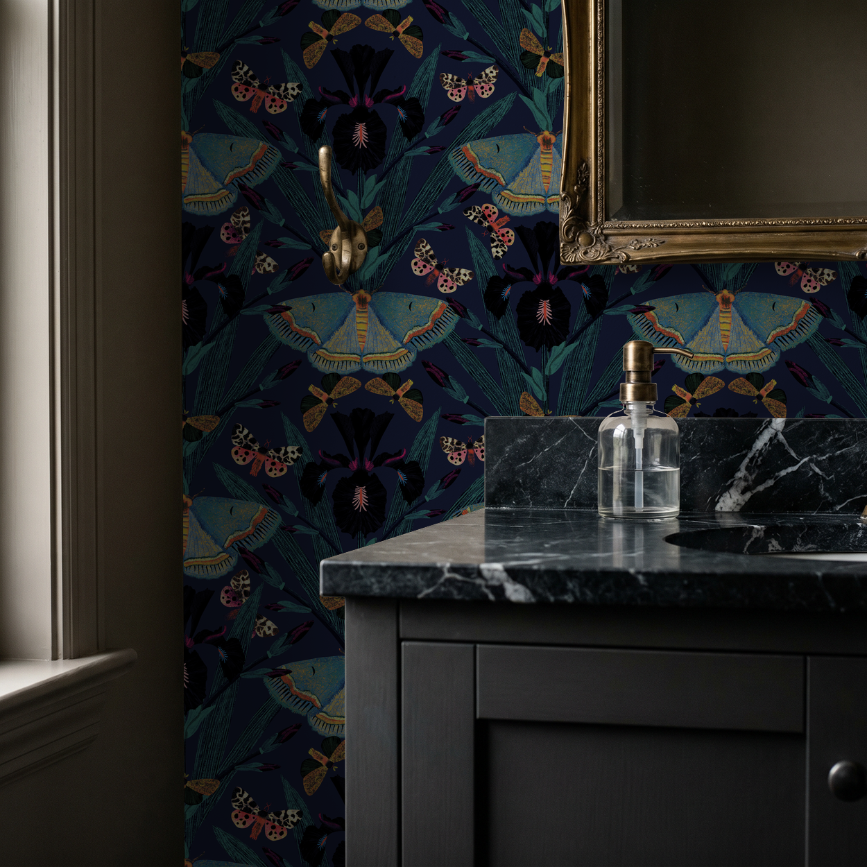 Moody navy wallpaper with moths and irises in elegant bathroom setting.