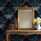Navy wallpaper with moths and irises behind ornate mirror and candles