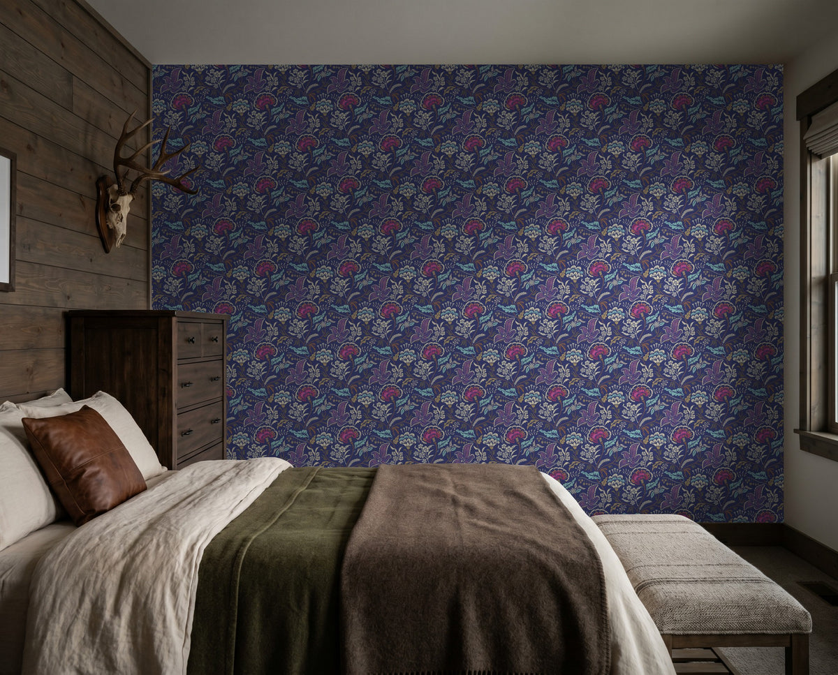 Pink and cream floral wallpaper with indigo background in cozy bedroom setting.