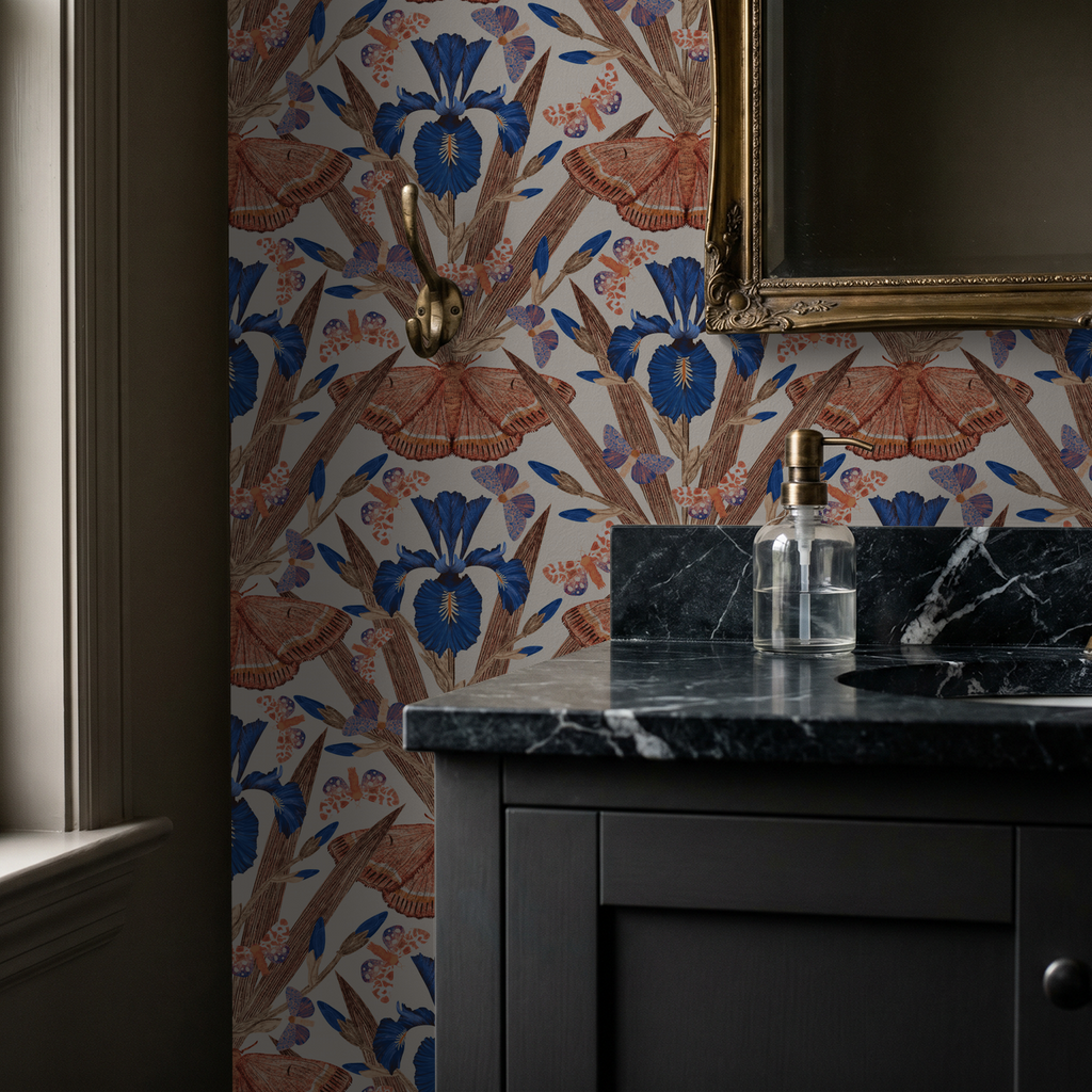 Terracotta and navy iris and moth wallpaper in elegant bathroom setting.